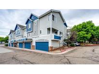 Charming townhouse with blue accents, attached garage, and well-maintained landscaping at 1372 S Cathay Ct # 104, Aurora, CO 80017
