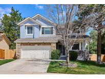 Charming two-story home featuring stone accents, a two-car garage and lovely landscaping at 15357 Flowergate Way, Parker, CO 80134