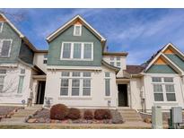 Charming two-story townhome with a well-maintained lawn and beautiful exterior architecture at 9612 W Indore Dr, Littleton, CO 80128