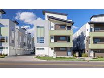 Modern three-story townhome with attractive exterior finishes and landscaping at 1615 Harlan St # 2, Lakewood, CO 80214