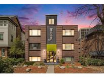 Charming brick apartment building with unique facade details and manicured landscaping at 1977 S Josephine St # 101, Denver, CO 80210