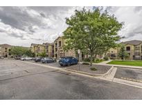 Attractive apartment complex featuring stone accents, well-maintained landscaping, and convenient parking at 9180 Rolling Way # 303, Parker, CO 80134
