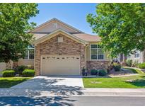 Charming home with a stone facade, two-car garage, lush lawn, and well-manicured landscaping at 3742 E 127Th Ln, Thornton, CO 80241