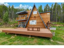 Stunning A-frame home with a large deck and a forest backdrop at 509 Paiute Rd, Evergreen, CO 80439