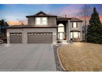 Beautiful two-story home with a three car garage, manicured lawn and a large entryway at 20790 Bridlewood Ln, Parker, CO 80138