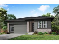 Charming single-story home featuring a modern garage door, a well-manicured lawn, and vibrant landscaping at 8577 Eckley St, Littleton, CO 80125