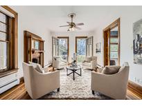 Cozy living room featuring a fireplace, plush seating, and balcony access for seamless indoor-outdoor living at 1284 N Corona St # B6, Denver, CO 80218