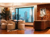Elegant dining room with city views, a unique chandelier, and stylish decor at 1133 14Th St # 3420, Denver, CO 80202