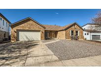 Charming single-story brick home with a two-car garage and a low-maintenance front yard at 1467 S Kenton St, Aurora, CO 80012