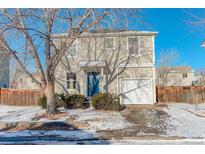 Two-story house with light beige siding, blue door, and attached garage at 1267 Bluejay Ave, Brighton, CO 80601