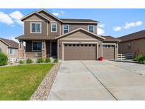 Beautiful two-story home with a three car garage, a covered porch, and well-maintained landscaping at 3008 Echo Park Dr, Castle Rock, CO 80104