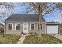 Charming single-story home with a well-maintained lawn and a detached garage, perfect for a starter home at 1745 Shallot Cir, Lafayette, CO 80026
