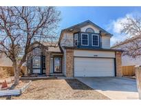 Charming two-story home featuring a two-car garage and well-maintained front yard at 10406 Drake Pl, Parker, CO 80134