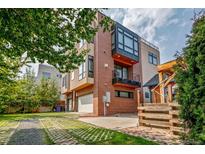 Contemporary brick home featuring attached garage, balcony, and modern architectural details at 3227 Quivas St # 1, Denver, CO 80211
