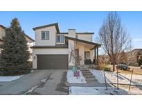 Modern two-story home with a dark grey garage door and manicured front yard at 17826 E 107Th Way, Commerce City, CO 80022