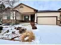 Charming single Gathering home with front yard landscaping and two car garage in winter at 12213 Joplin St, Commerce City, CO 80603