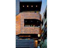Modern home featuring unique wood paneling and lighting, creating a warm and inviting exterior at 1919 W 32Nd Ave, Denver, CO 80211