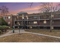 Brick apartment building with walkways and covered entrances, set in a landscaped common area at 6800 E Tennessee Ave # 411, Denver, CO 80224