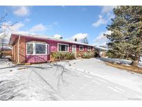 Charming single-story home with brick and siding, complemented by a snowy front yard under a blue sky at 805 38Th St, Boulder, CO 80303