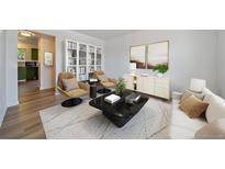 Bright living room with modern furniture, stylish decor, and an open-concept layout showcasing seamless flow to the kitchen at 16251 E 17Th Pl # C, Aurora, CO 80011