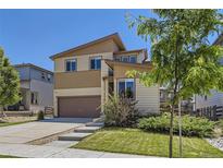 Two-story home featuring a two-car garage, neutral siding, and well-maintained landscaping at 10808 Salida St, Commerce City, CO 80022