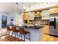 Modern kitchen with sleek countertops, stainless steel appliances, and adjacent outdoor patio access at 2240 N Clay St # 501, Denver, CO 80211