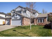 Charming two-story home with a well-manicured lawn, a two-car garage, and appealing architectural details at 1009 Monarch Way, Superior, CO 80027