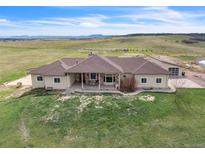 Expansive ranch home with a covered patio and an additional building on acreage at 15125 Spring Valley Rd, Larkspur, CO 80118