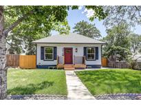 Charming single-story home with a red front door, fresh grass, and a sidewalk leading to the entrance at 4818 Bryant St, Denver, CO 80221