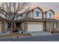 Charming townhouse features a two-car garage and a mix of brick and neutral siding at 3035 S Indiana St, Lakewood, CO 80228
