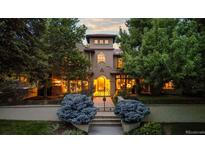 Elegant home featuring a landscaped front yard, gated entry, and well-lit facade at 235 Eudora St, Denver, CO 80220