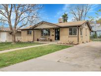 Charming brick ranch home with a well-manicured lawn and inviting front porch at 4108 S Inca St, Englewood, CO 80110