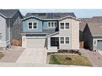 Charming two-story home with a mix of stone and siding, enhanced by solar panels on the roof at 4757 Augustine Ct, Castle Rock, CO 80108