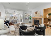 Bright living room featuring modern furniture, a fireplace, and an open floor plan leading to the dining area at 3613 Silverton St, Boulder, CO 80301