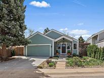 Charming single-Gathering home with a well-manicured lawn and a two-car garage in a quiet neighborhood at 10624 W Berry Pl, Littleton, CO 80127