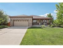 Charming brick home with a well-maintained lawn and covered front porch for relaxing and curb appeal at 2864 S Jebel Way, Aurora, CO 80013
