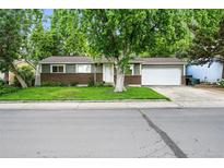 Charming single-story home with a well-manicured front lawn and attached two car garage at 11625 Bellaire Way, Thornton, CO 80233