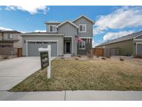 Charming two-story home with manicured lawn, a two-car garage, and a For Sale sign at 6954 E 117Th Ave, Thornton, CO 80233