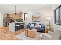 Bright and airy living room featuring hardwood floors, a modern coffee table, and comfortable seating at 1715 Grove St, Denver, CO 80204