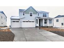 Charming two-story home featuring a three-car garage and inviting front porch with snow-covered landscape at 39856 Floyd St, Elizabeth, CO 80107