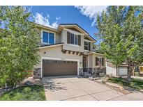 Charming two-story home boasts a two-car garage, well-maintained landscaping, and inviting curb appeal in a friendly neighborhood at 10528 Applebrook Cir, Highlands Ranch, CO 80130