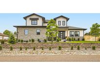 Beautiful two-story home with stone accents, manicured landscaping, and a charming modern farmhouse design at 8623 S Wadsworth Ct, Littleton, CO 80128