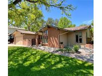 Charming home features a brick exterior, well-maintained lawn, garden and attached garage at 7019 S Windermere St, Littleton, CO 80120