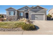 Gray two-story house with stone accents and a two-car garage at 3153 Eagle Claw Pl, Castle Rock, CO 80108