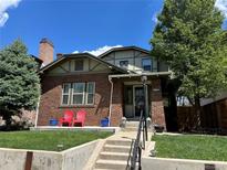 Charming brick home with well-maintained lawn, mature trees, and a cozy front porch perfect for relaxing at 726 S Corona St, Denver, CO 80209