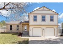 Charming two-story home featuring a well-maintained yard and a convenient two-car garage in a tranquil neighborhood at 6782 Hills Dr, Parker, CO 80138