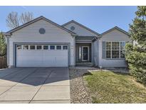 Charming single-Gathering home featuring a two-car garage, manicured lawn, and inviting entrance at 20344 Heather Ln, Parker, CO 80138