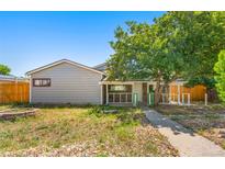 Cozy home featuring a charming stone porch, quaint yard, and inviting walkway at 5942 Poplar St, Commerce City, CO 80022
