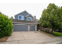 Charming two-story home featuring a two-car garage, well-maintained lawn, and mature landscaping at 8927 Green Meadows Ln, Highlands Ranch, CO 80126