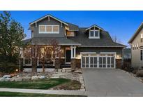 Charming two-story home featuring stone accents, a two-car garage, and a well-manicured front yard at 12187 S Hidden Trail Ct, Parker, CO 80138